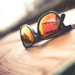 Amber reflective sunglasses wooden surface background image & Google Slides Theme