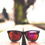 Black Sunglasses Wooden Surface background image & Google Slides Theme