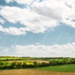 Blue Sky Green Yellow Fields background image & Google Slides Theme