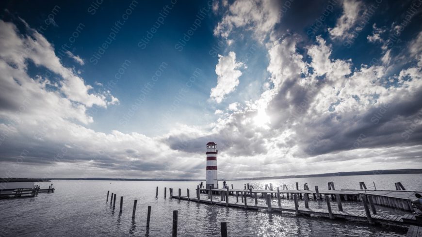 Blue Sky Grey Clouds Red White Lighthouse Wooden Pier Water background image