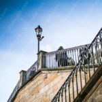 Blue Sky Stone Stairs Lamp Post People background image & Google Slides Theme
