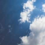 Deep Blue Sky White Clouds background image & Google Slides Theme