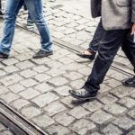 Greyscale WalkingFeet CobblestonePavement background image & Google Slides Theme