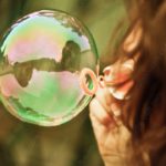 Iridescent bubble person background image & Google Slides Theme