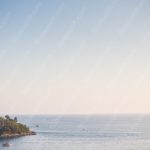 Pale blue to peach gradient sea and island background image & Google Slides Theme