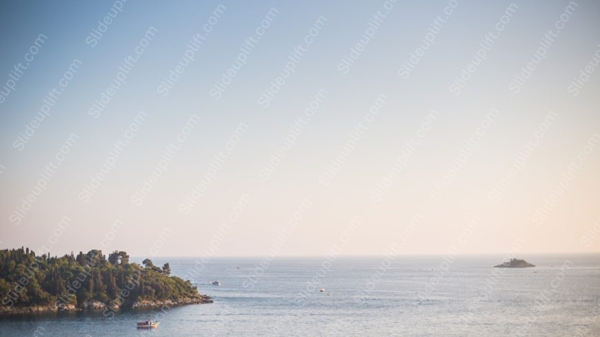 Pale blue to peach gradient sea and island background image