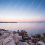 Pastel Pink Blue Sky Rocks Shoreline background image & Google Slides Theme