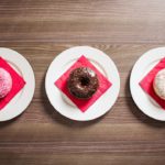 Pink Chocolate White Doughnuts on Red Napkins Wooden Table background image & Google Slides Theme