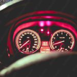 Red Glowing Speedometer and Tachometer Nighttime Driving background image & Google Slides Theme