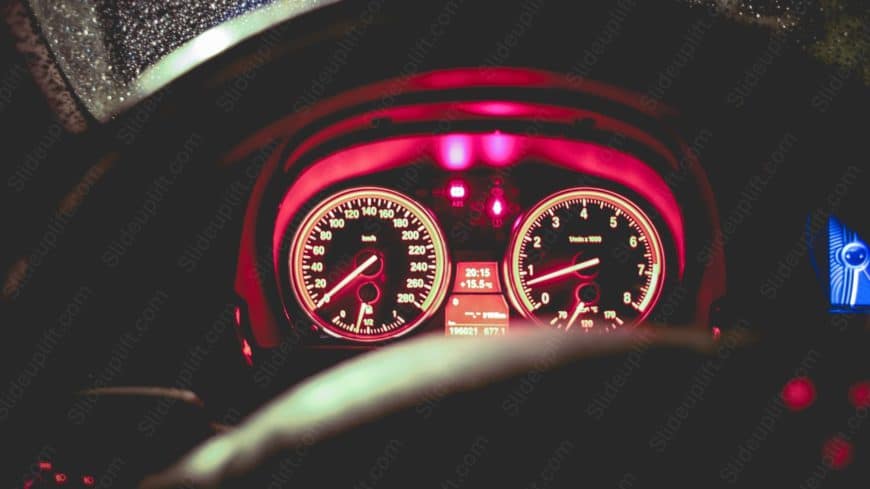 Red Glowing Speedometer and Tachometer Nighttime Driving background image