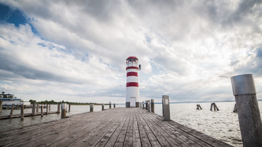 Red White Lighthouse Wooden Pier Dramatic Sky background image