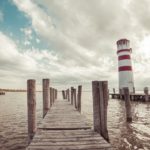 Red White Lighthouse Wooden Pier Water background image & Google Slides Theme