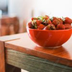 Red strawberries bright bowl wooden table background image & Google Slides Theme