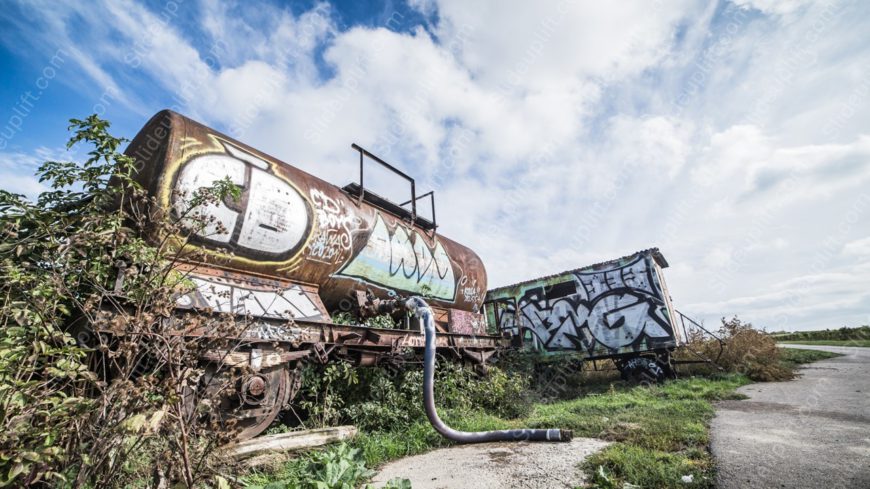 Rust Brown Graffiti Train Carriage Sky Blue background image