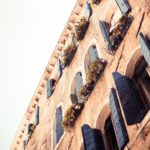 Sepia Toned Building Facade with Shutters background image & Google Slides Theme