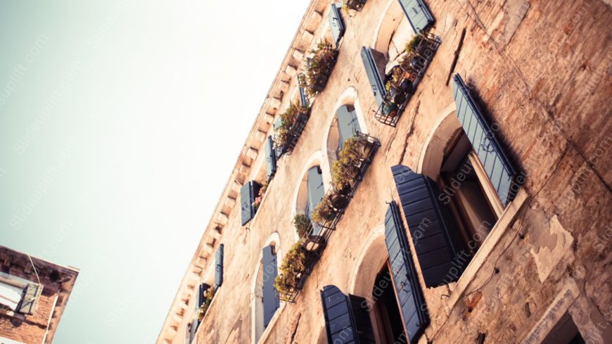 Sepia Toned Building Facade with Shutters background image