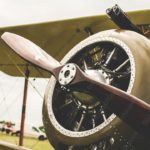 Silver Biplane Engine With Propeller Green Grass background image & Google Slides Theme