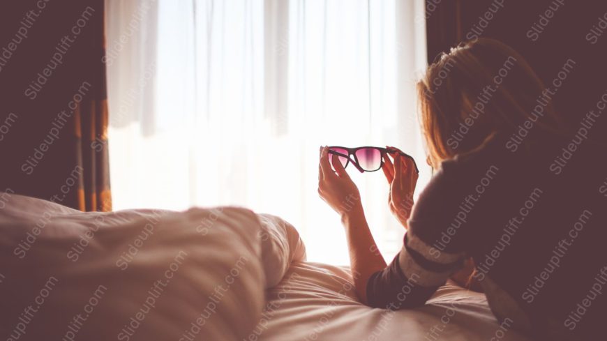 Soft white person holding pink sunglasses background image