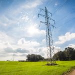 Vivid green field and metal electricity pylon sunny sky background image & Google Slides Theme