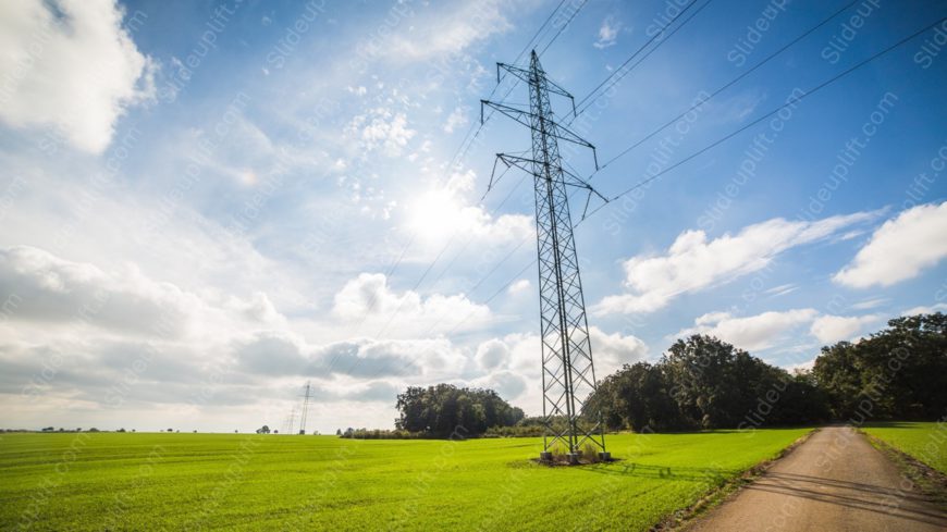 Vivid green field and metal electricity pylon sunny sky background image