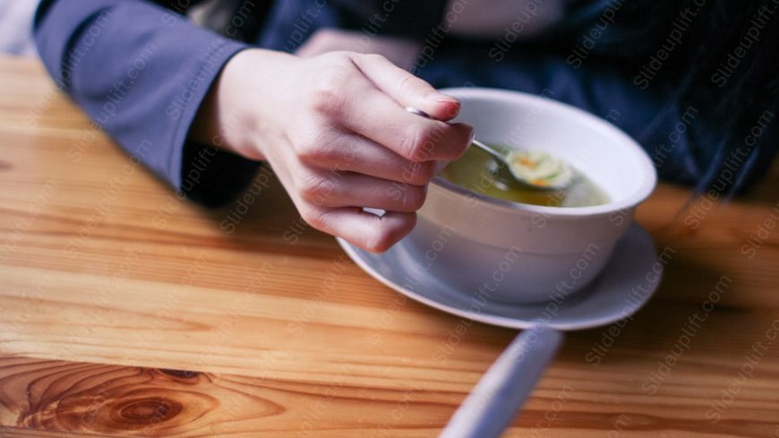 Warm browns wooden table Navy sleeve hand Soup bowl background image