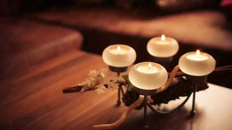 Warm white candles and pinecone on table background image & Google Slides Theme