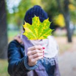 Yellow Green Maple Leaf Person Holding Fall Scene background image & Google Slides Theme