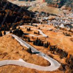 Autumn hued Mountain Town and Winding Road background image & Google Slides Theme