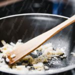 Black FryingPan BrownWoodenSpoon CookingOnions background image & Google Slides Theme