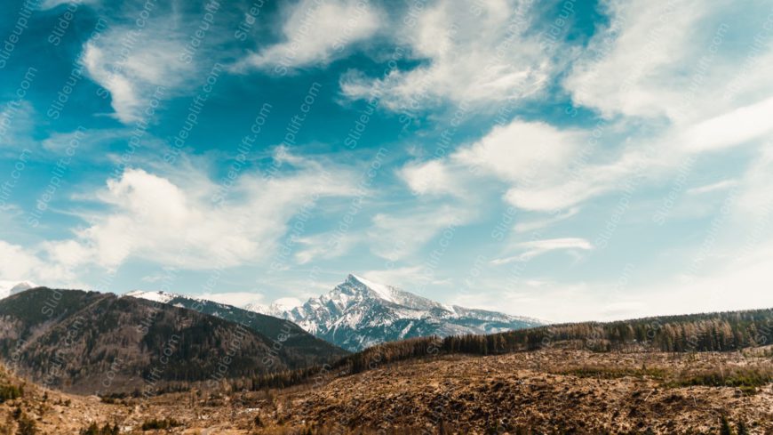 Blue Sky White Clouds Brown Mountain Green Trees background image