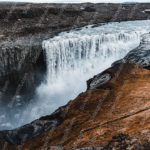 Blue White Waterfall Brown Terrain background image & Google Slides Theme