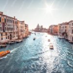 Blue water orange boats brown buildings background image & Google Slides Theme