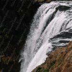 Dark Brown Green White Waterfall River background image & Google Slides Theme