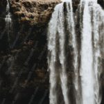 Dark brown rock waterfall background image & Google Slides Theme