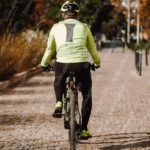 Lime Green Jacket Cyclist Urban Path background image & Google Slides Theme