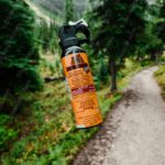 Orange Black Bear Spray Can Forest Path background image & Google Slides Theme