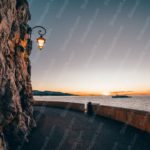 Orange Blue Sunset Ocean Lamppost Seawall background image & Google Slides Theme