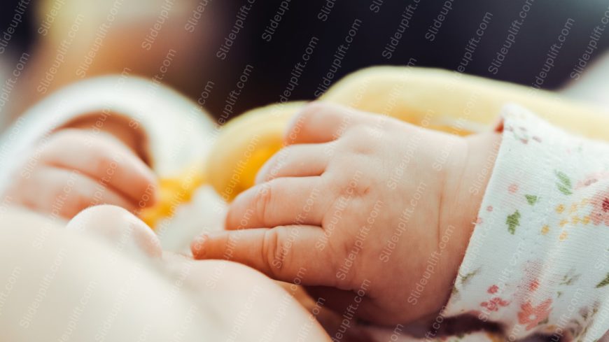 Peach Cream Baby Hand on Yellow Blanket background image