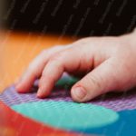 Peach Orange Purple Green Turquoise Child_s Hand Foam Mat background image & Google Slides Theme