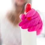 Pink Gloved Hand with Spray Bottle background image & Google Slides Theme