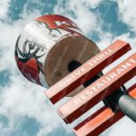 Red and White Signpost Spherical Object Cloudy Sky Background Image & Google Slides Theme