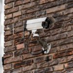 Silver Security Camera Brick Wall background image & Google Slides Theme