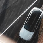 White Car on Gray Road With Cobblestone Sidewalk background image & Google Slides Theme