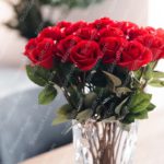 Crimson Roses In Clear Vase Background Image & Google Slides Theme