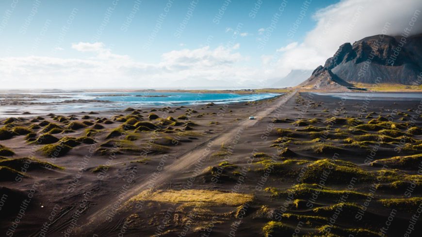 Emerald Grass Black Sand Road Coastal Mountain Background Image