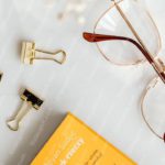 Gold Clips Brown Glasses Yellow Book Background Image & Google Slides Theme