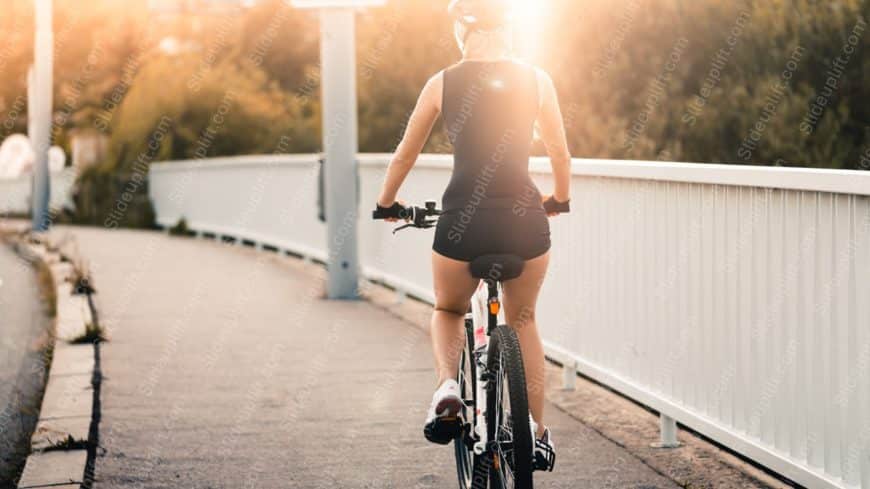 Golden Woman Cycling Warm Evening Background Image