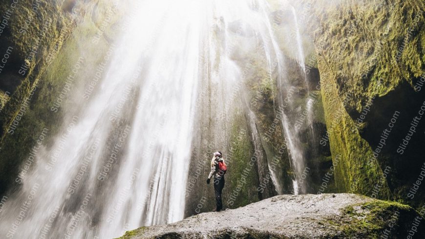 Green Mossy Waterfall And Person Background Image