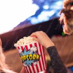 Red White Striped Popcorn Bucket Dog Woman Background Image & Google Slides Theme