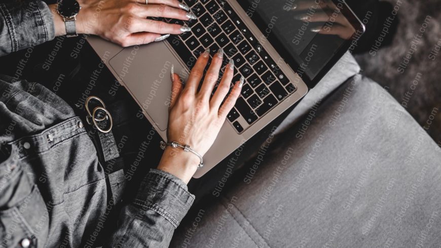 Silver Laptop On Gray Couch Background Image